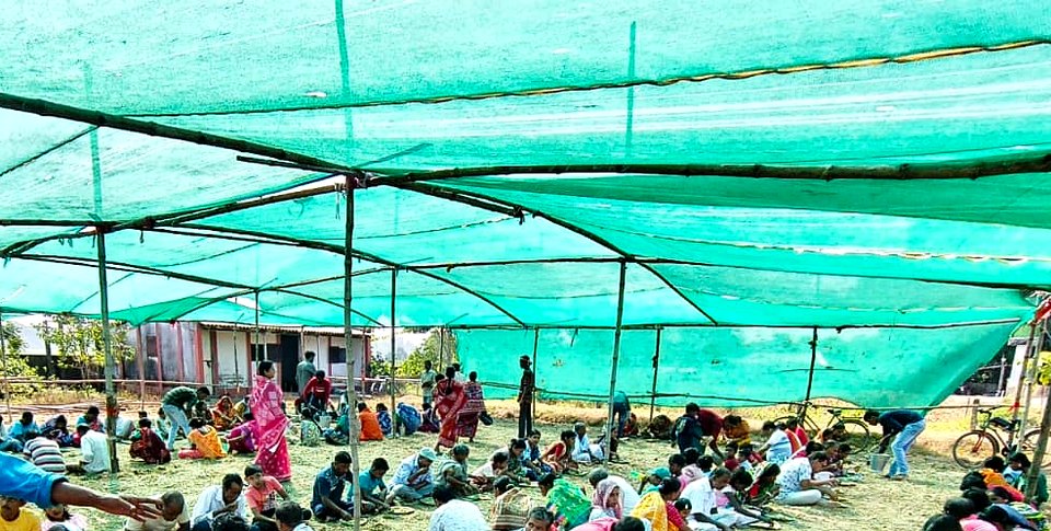 A community meal under a shamiana at the Ashram.