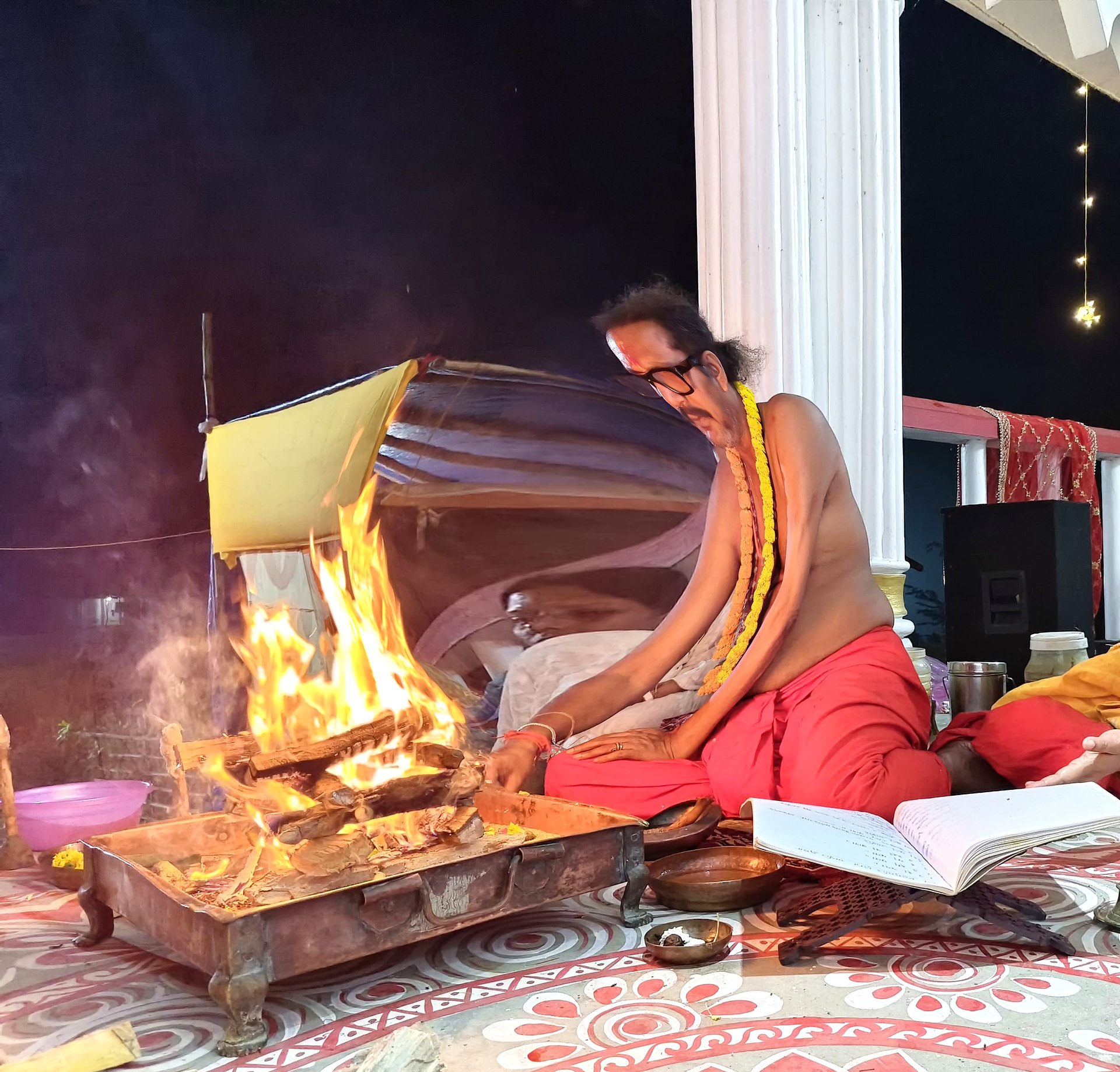 Sri Meenananda Tirthanath at night homa, fire rising from the kunda.