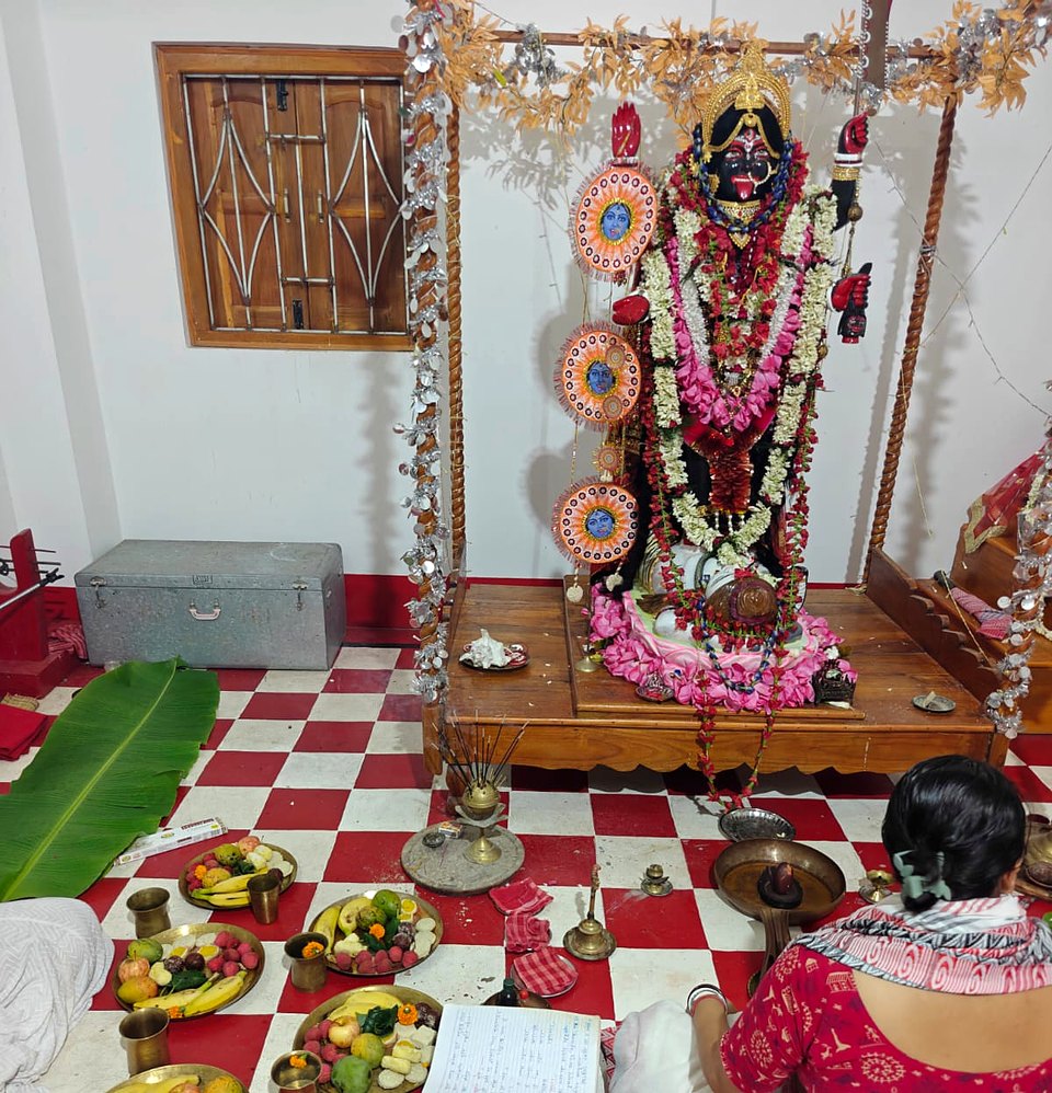 Fruit offerings arranged before Maa Kali in the shrine room.