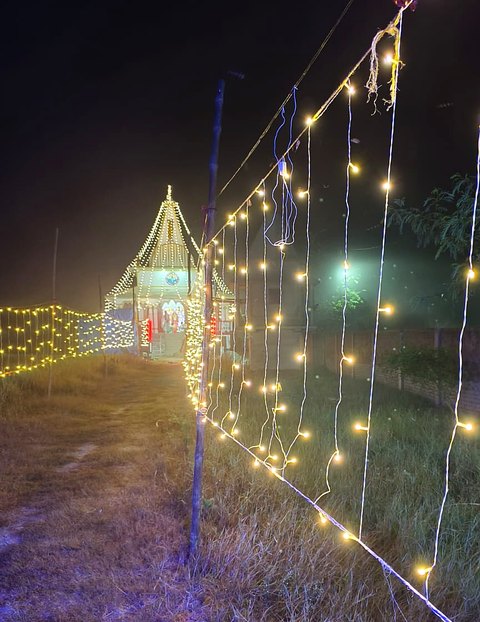The Ashram shrine at night, outlined with lights.